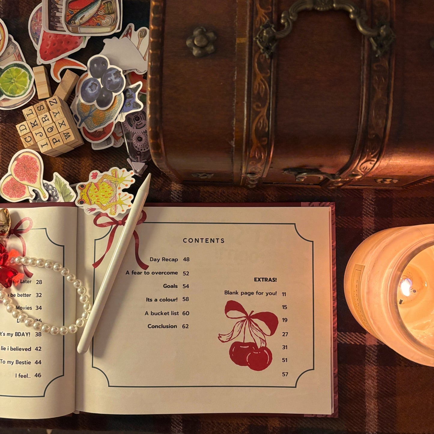 Contents page of Scrap Journal Guide styled with pen, candle, stickers, and vintage chest in a cozy flat lay