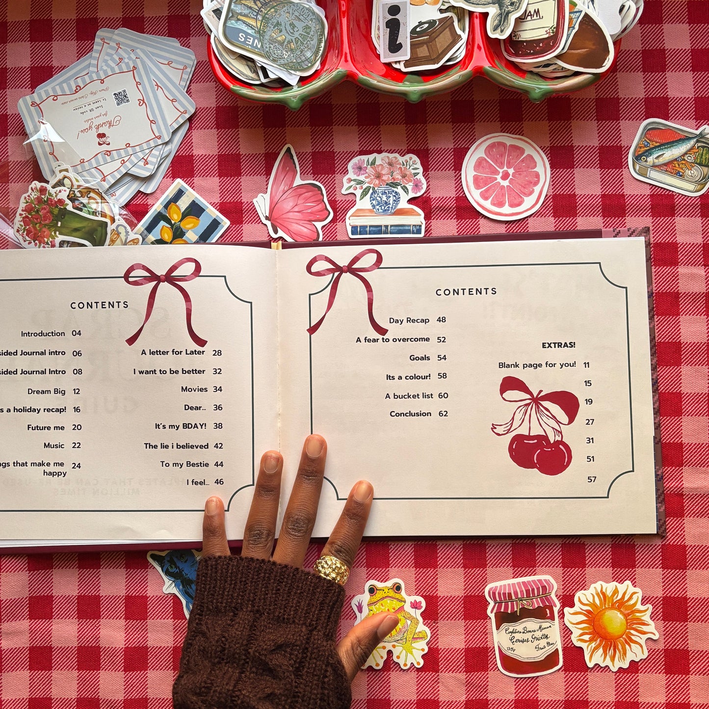 Contents pages of Scrap Journal Guide showing journaling prompts and section titles on red gingham background